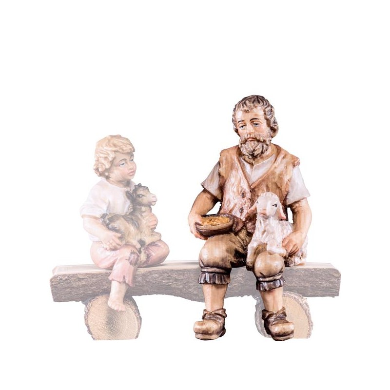 Shepherd sitting with lamb...